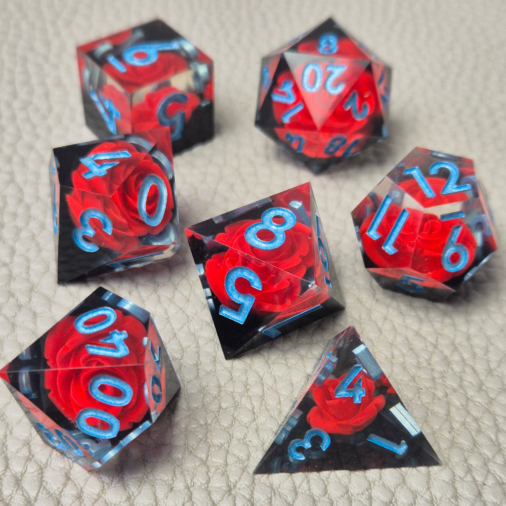 A set of clear sharp-edge resin dice with black ground color and red rose inside.