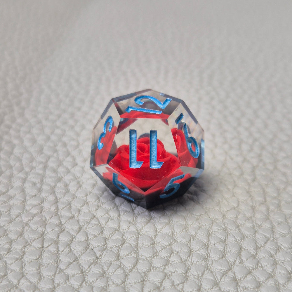 A set of clear sharp-edge resin dice with black ground color and red rose inside.