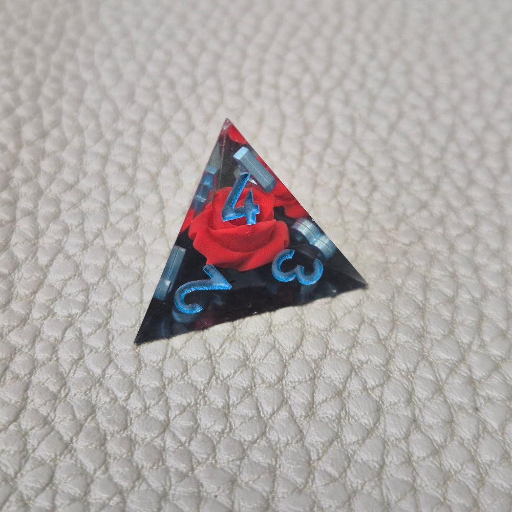 A set of clear sharp-edge resin dice with black ground color and red rose inside.