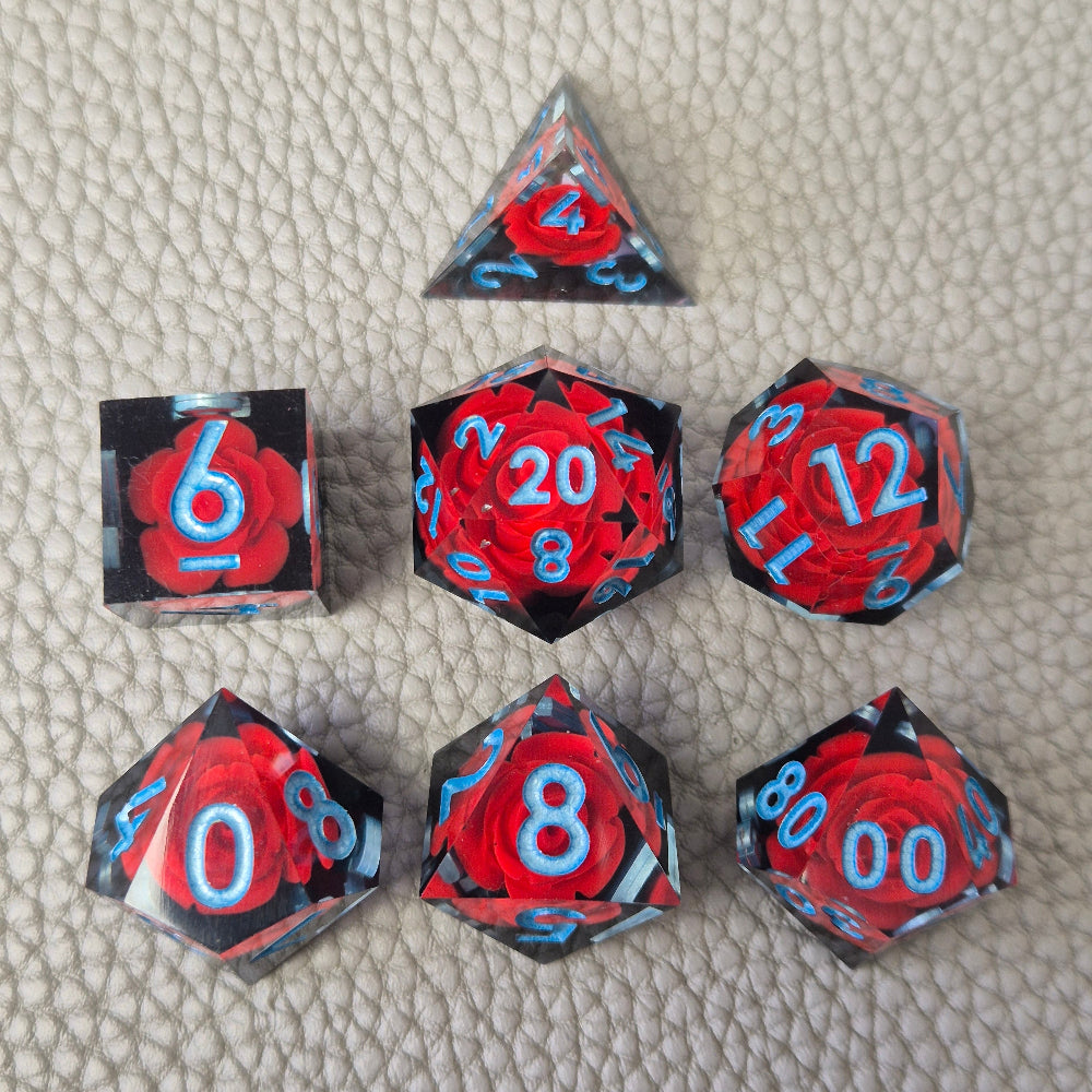 A set of clear sharp-edge resin dice with black ground color and red rose inside.