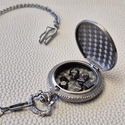 A silver coloured full metal pocket watch themed dice locket, with engraved backside and detailed dragon on the front. Contains full set of metal dice inside