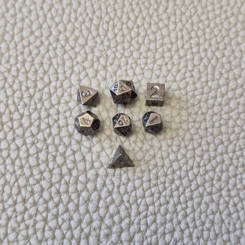 A silver coloured full metal pocket watch themed dice locket, with engraved backside and detailed dragon on the front. Contains full set of metal dice inside