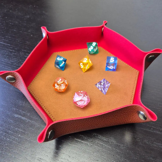 Foldable hexagon-shaped dice trays in red & brown shown open and filled with colorful polyhedral dice.