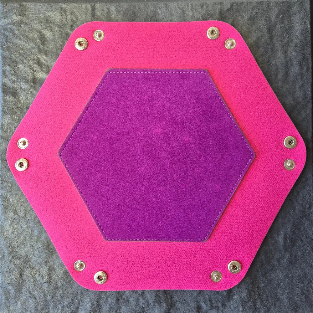 Foldable hexagon-shaped dice trays in pink & purple shown open.