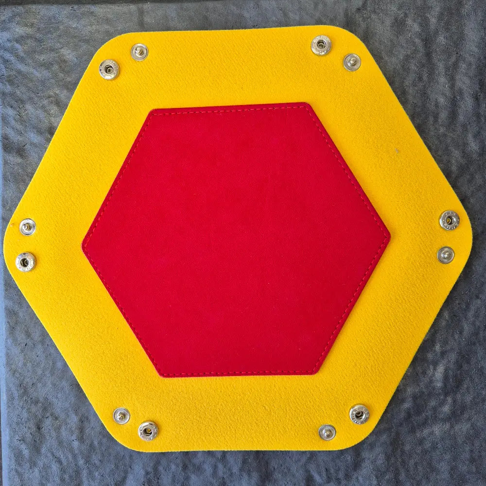 Foldable hexagon-shaped dice tray in yellow & red.