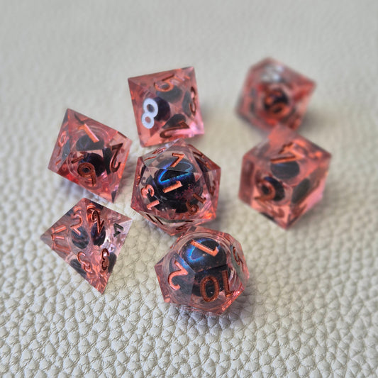A set of red tinted clear liquid core dice with a moving dragon eye inside on a white textured background