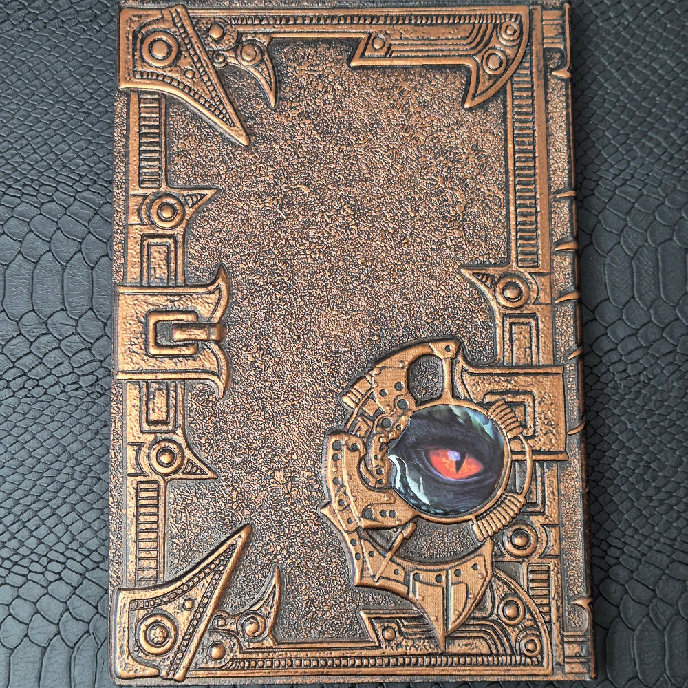 A bronze coloured notebook/journal for DND and other TTRPG games