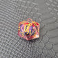 A set of clear red tinted liquid core resin dice with a moving dragon eye inside, displayed on a black textured surface