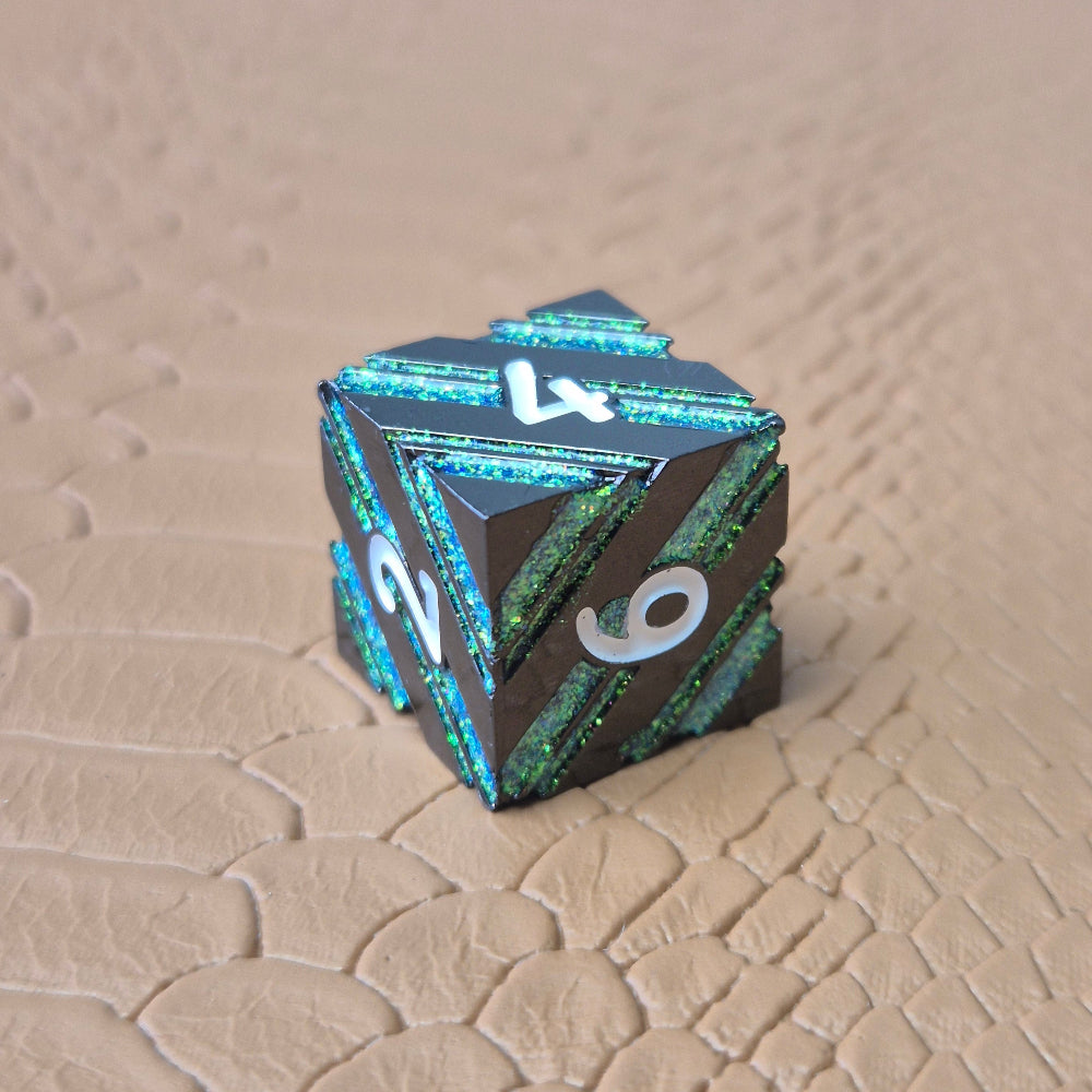 A set of black metal dice with shimmering green stripes and white numbering, displayed on a textured surface.