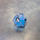Blue sharp edge resin dice set with liquid core and black cat stickers on metal plate