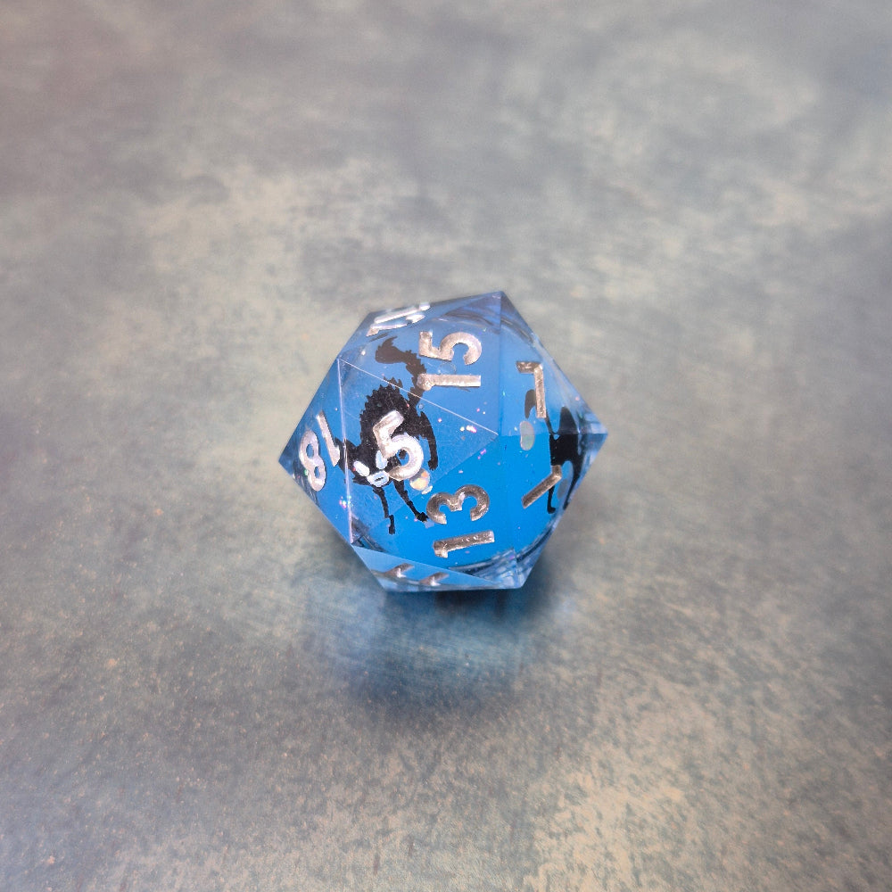 Blue sharp edge resin dice set with liquid core and black cat stickers on metal plate