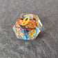A set of clear blue tinted sharp edge resin dice with an engraved golden ring inside on a black surface