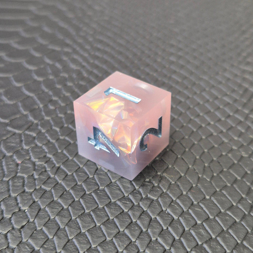 A set of pink sharp edge resin dice with blue numbers on a black textured surface
