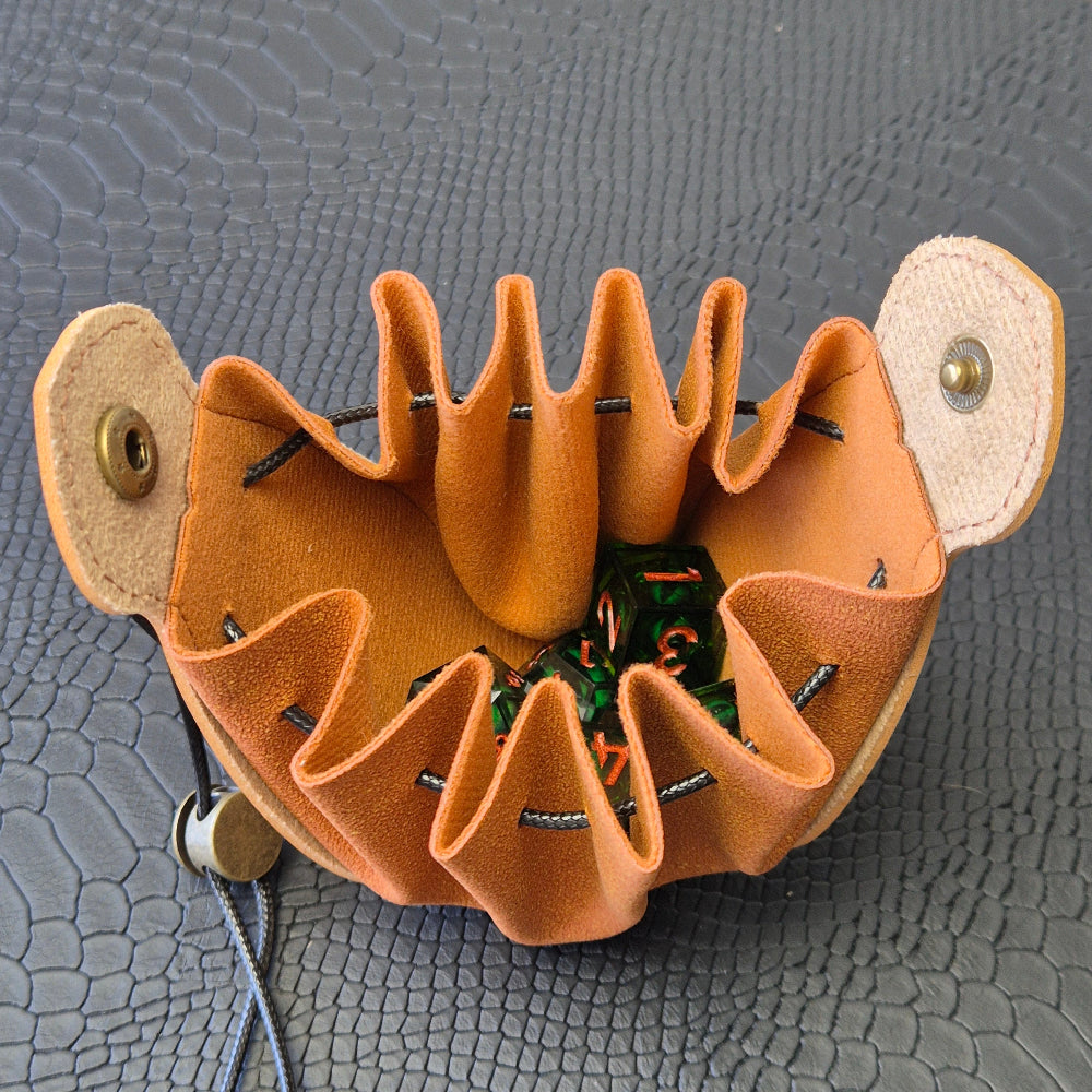 A brown leather dice bag with buttons and rope to tightly close it. Displayed on a black textured background