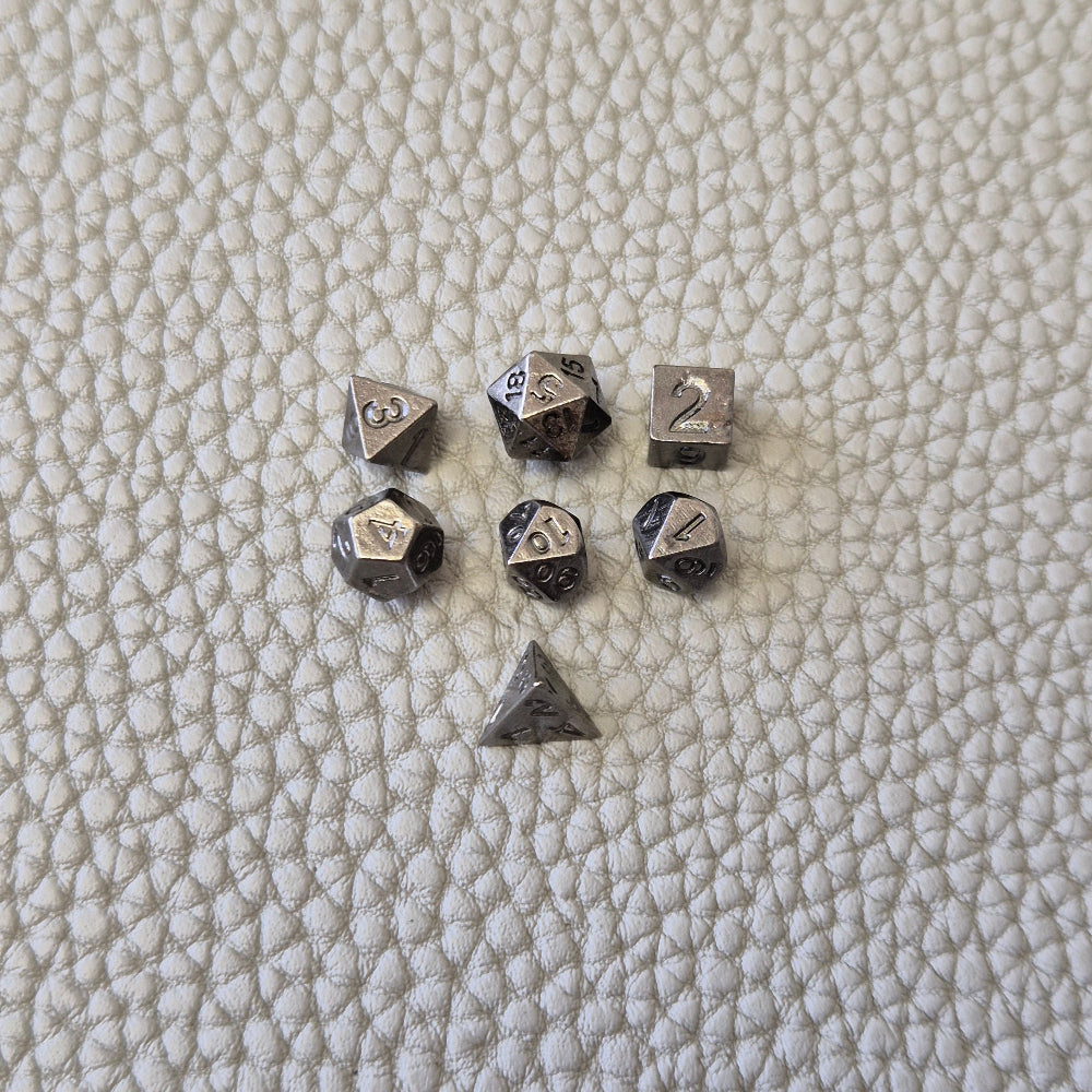 A silver coloured full metal pocket watch themed dice locket, with engraved backside and detailed kraken on the front. Contains full set of metal dice inside