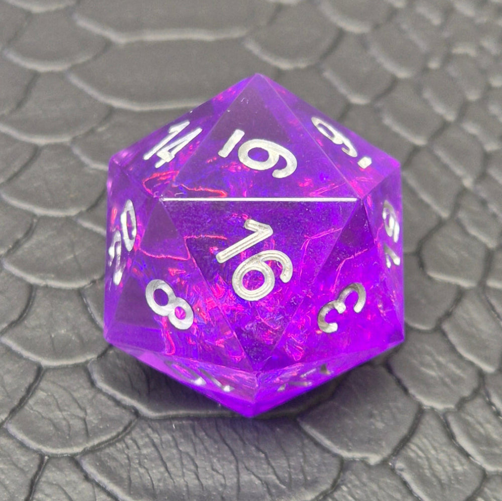 A D20 sharp-edge purple resin dice and silver numbering, displayed on a black scale-textured surface.