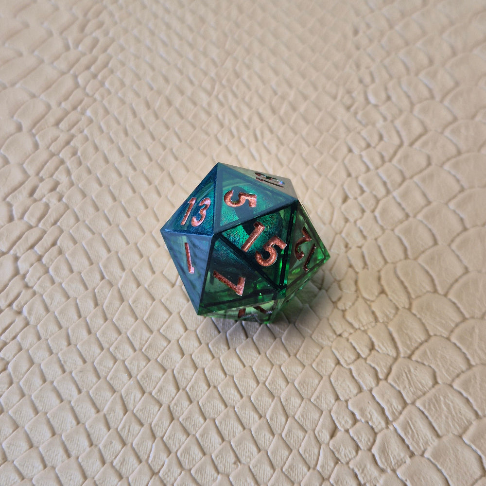 A set of clear green tinted liquid core dice with a moving eyeball inside