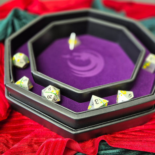 Purple double-layered octagonal dice tray with black borders and a violet dragon emblem in the center, displayed on a textured surface.