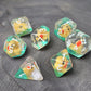 Close-up of transparent resin dice with tiny yellow ducks inside, placed on a textured stone surface.