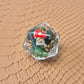 Clear resin D20 with red mushroom and moss encased inside, golden numbers, set on a textured leather background.